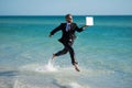 Excited millennial hispanic business man in suit on sea. Summer vacation, business on sea beach. 40s business man on Royalty Free Stock Photo