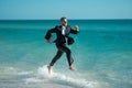 Excited millennial hispanic business man in suit on sea. Summer vacation, business on sea beach. 40s business man on Royalty Free Stock Photo