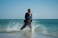 Excited millennial hispanic business man in suit on sea. Summer vacation, business on sea beach. 40s business man on Royalty Free Stock Photo