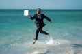 Excited millennial hispanic business man in suit on sea. Summer vacation, business on sea beach. 40s business man on Royalty Free Stock Photo