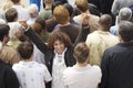 Excited Mixed Race Man Amid Rear View Of Multiethnic Crowd