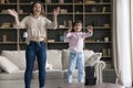 Excited mom and daughter kid dancing at smartphone frontal camera Royalty Free Stock Photo