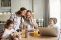 Excited mother exchanging looks with her son at kitchen table