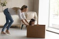 Excited mother with little daughter playing pirates at home together