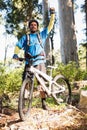 Excited mountain biker in forest