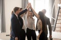 Excited multicultural business people give high five engaged in teambuilding Royalty Free Stock Photo