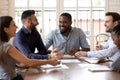 Smiling diverse millennial colleagues have fun at meeting Royalty Free Stock Photo