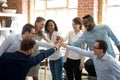 Excited diverse workers join hands at teambuilding activity Royalty Free Stock Photo