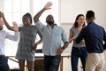 Excited multiracial team dancing celebrating success in business in office Royalty Free Stock Photo