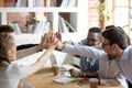 Excited multiracial team giving high five at company meeting Royalty Free Stock Photo