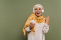 Excited multiracial woman in hijab and