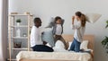 Happy multinational family pillow fight in bedroom Royalty Free Stock Photo