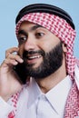 Excited arab answering smartphone call Royalty Free Stock Photo