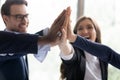 Excited office employees giving group high five Royalty Free Stock Photo