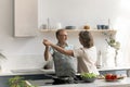 Excited older married couple celebrating anniversary, dancing to music Royalty Free Stock Photo