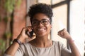 Excited african woman talking on phone happy about good news Royalty Free Stock Photo