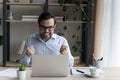 Excited overjoyed businessman feeling euphoria at computer