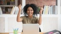 Excited overjoyed ecstatic african businesswoman winner celebrating online win Royalty Free Stock Photo