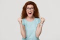 Excited overjoyed young redhead woman feel happy looking at camera Royalty Free Stock Photo