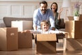 Excited parents with little son having fun on moving day Royalty Free Stock Photo