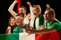 Excited people standing with flag of country. Football, soccer fans emotionally cheering up favourite team during match Royalty Free Stock Photo