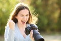 Excited photographer checking photos on mirrorless camera