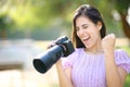 Excited photographer in a park checking results Royalty Free Stock Photo