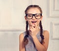 Excited positive thinking kid girl in fashion glasses with emotional natural smiling face looking on studio background. Closeup t Royalty Free Stock Photo