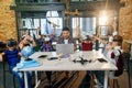 Preteen students using augmented reality for studying in modern smart school. Group of pupils with VR headsets during a Royalty Free Stock Photo