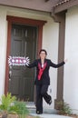 Excited Real Estate Agent In Front of Home - Sold! Royalty Free Stock Photo