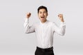 Excited, rejoicing young asian successful businessman celebrating win, become champion, achieve goal, fist pump and Royalty Free Stock Photo