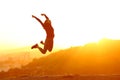 Excited runner jumping at sunset in city outskirts Royalty Free Stock Photo