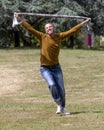 Excited 40s man expressing euphoria and freedom in park