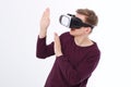 Excited and scared young man in a VR headset, glasses. Virtual reality isolated on white background. Copy space and mock up Royalty Free Stock Photo