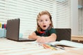 Excited school boy writing at notebook in classroom at the elementary school. Little student doing test in primary Royalty Free Stock Photo