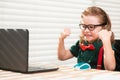 Excited schoolboy using a laptop and study online lesson. Pupil at school. Cute child using laptop computer, studying Royalty Free Stock Photo