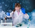 Excited schoolgirl in fume after chemical experiment