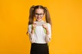 Excited Schoolgirl Using Smartphone Playing Game During Break, Studio Shot