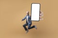 Excited senior man jumping with huge smartphone in hand, mockup Royalty Free Stock Photo