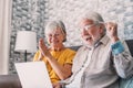 Excited senior mature couple surprised by good unbelievable news, unexpected win, huge shopping sale offer on website, astonished Royalty Free Stock Photo