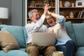 Excited senior mature couple surprised by good unbelievable news, unexpected win, huge shopping sale offer on website, astonished Royalty Free Stock Photo