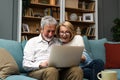 Excited senior mature couple surprised by good unbelievable news, unexpected win, huge shopping sale offer on website, astonished Royalty Free Stock Photo