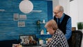 Excited senior woman and her husband having video conference on laptop Royalty Free Stock Photo