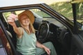 Excited senior woman sitting in new car outdoors holding keys, smiling, enjoying newly bought auto. Driving courses Royalty Free Stock Photo