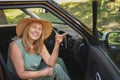 Excited senior woman sitting in new car outdoors holding keys, smiling, enjoying newly bought auto. Driving courses Royalty Free Stock Photo