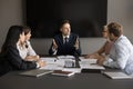 Excited serious company director man talking with employees Royalty Free Stock Photo