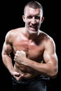 Excited shirtless man flexing muscles Royalty Free Stock Photo