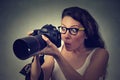 Excited shocked woman with professional DSLR camera Royalty Free Stock Photo