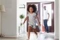 Excited little girl run into own home with young parents Royalty Free Stock Photo