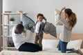 Excited small mixed race kid boy having fun with parents.